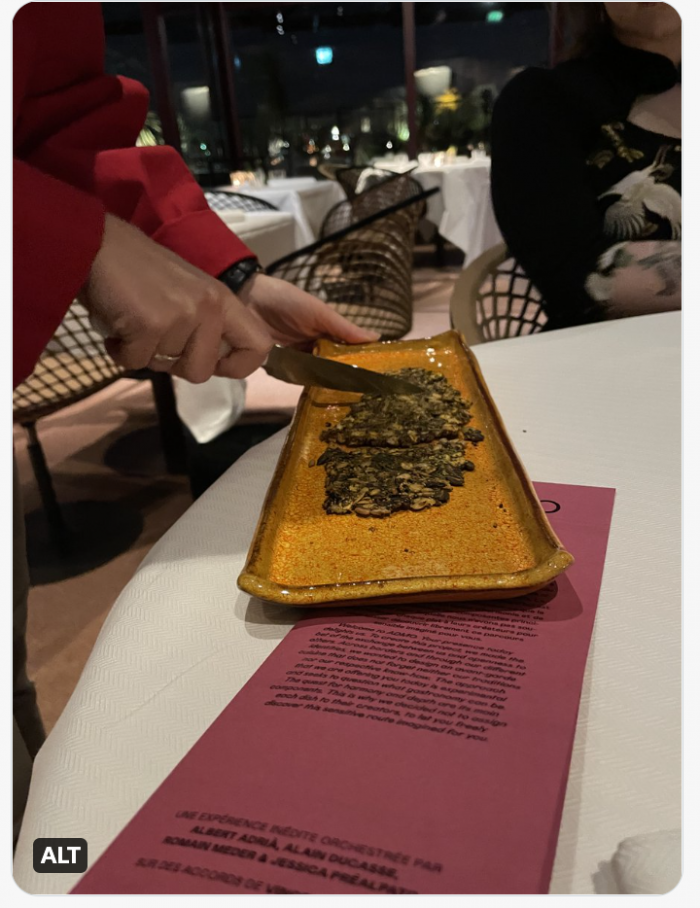 Our server cracking the cracker on a long ceramic platter